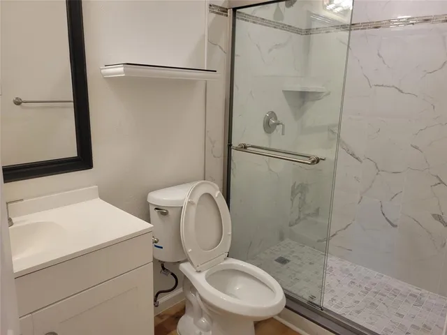 a bathroom with a toilet sink and a shower