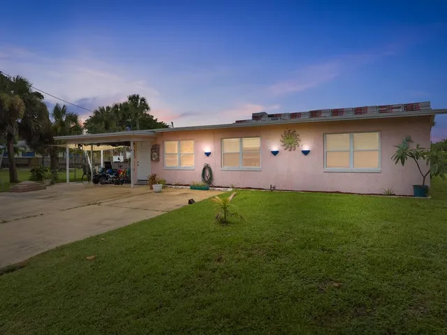 a backyard of a house with table and chairs