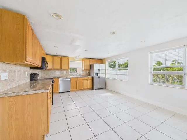 a kitchen with stainless steel appliances granite countertop a sink and cabinets