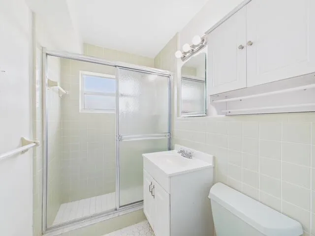 a bathroom with a toilet sink and shower