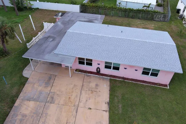 an aerial view of a house with a yard