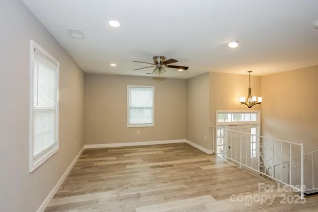 a view of a kitchen with a sink and dishwasher kitchen view and wooden floor