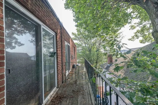 a view of balcony with wooden floor and fence