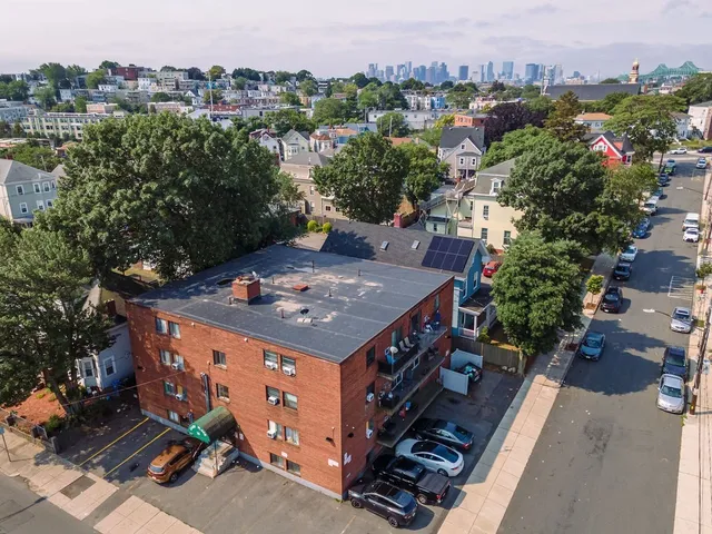 an aerial view of a house with a yard