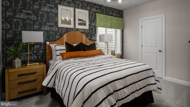 a bedroom with a bed lamp and a window