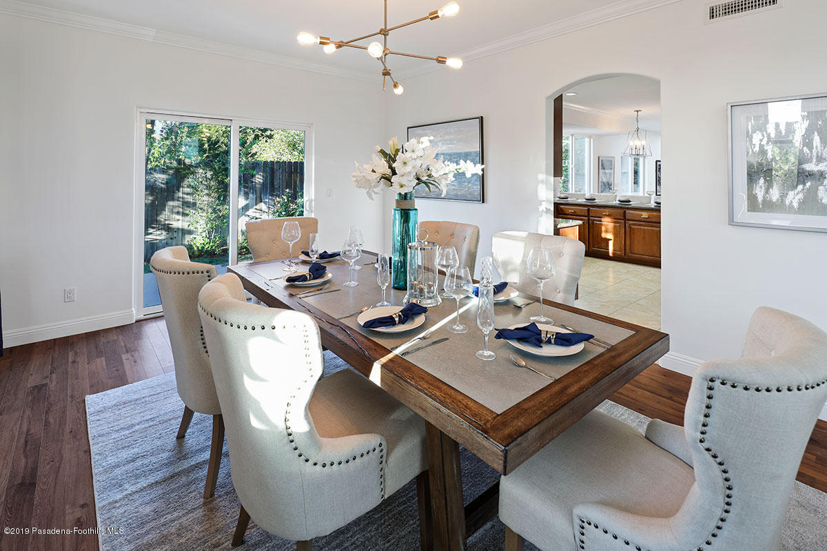 7215 Summitrose Street Tujunga, CA 91042 - Photo 13 of 47 a view of a dining room with furniture a rug and wooden floor