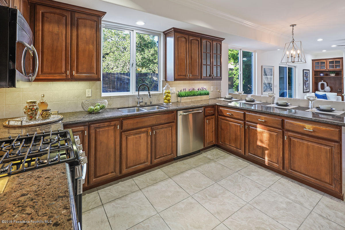 7215 Summitrose Street Tujunga, CA 91042 - Photo 15 of 47 a kitchen with stainless steel appliances granite countertop a sink stove and cabinets
