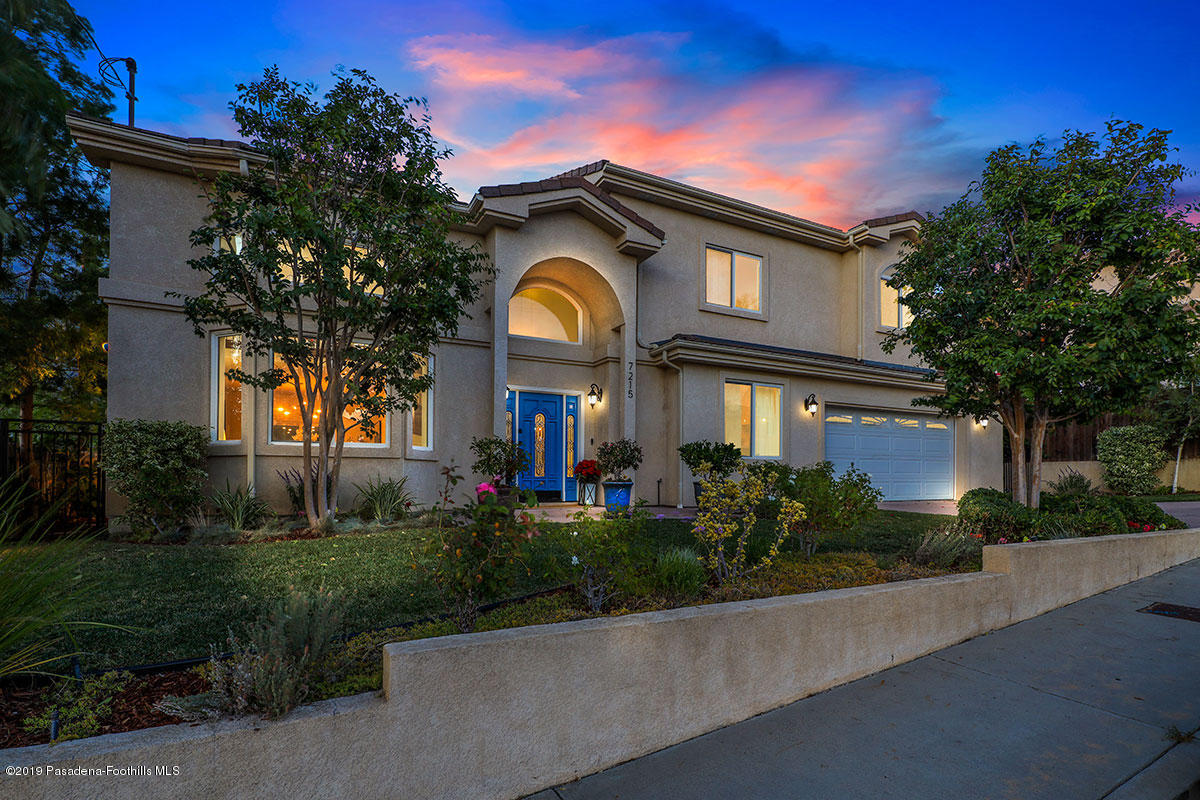 7215 Summitrose Street Tujunga, CA 91042 - Photo 2 of 47 a front view of a house with a garden