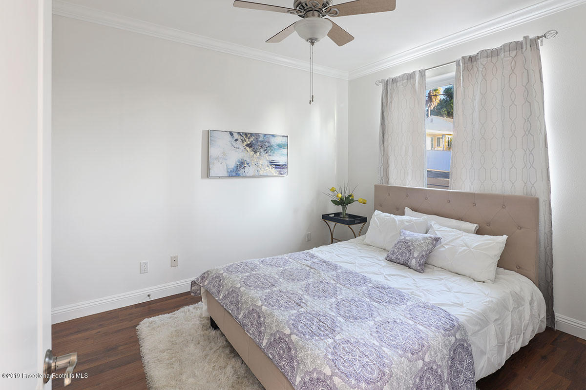 7215 Summitrose Street Tujunga, CA 91042 - Photo 23 of 47 a bedroom with a bed and a painting on the wall
