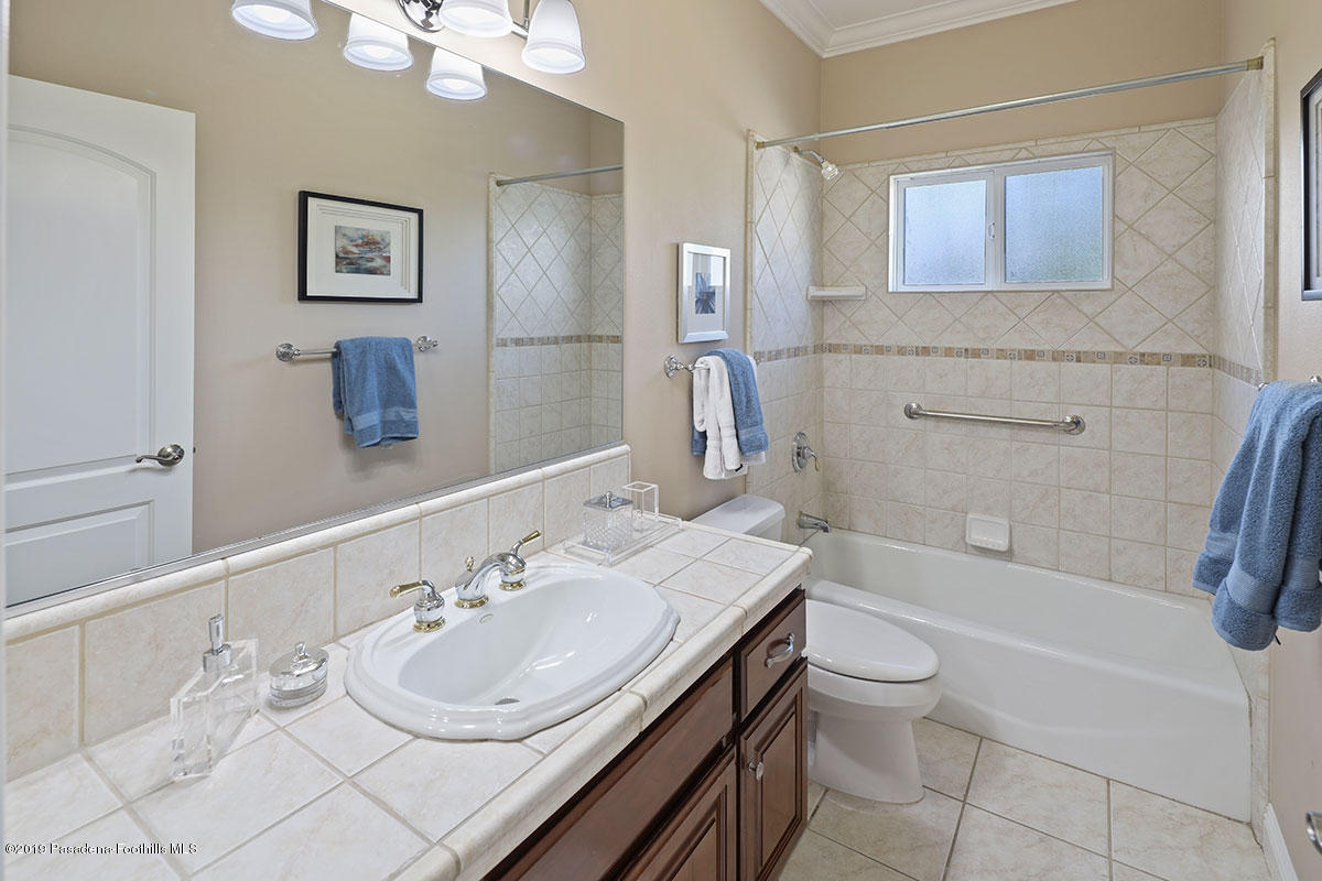 7215 Summitrose Street Tujunga, CA 91042 - Photo 32 of 47 a bathroom with a granite countertop sink toilet and shower