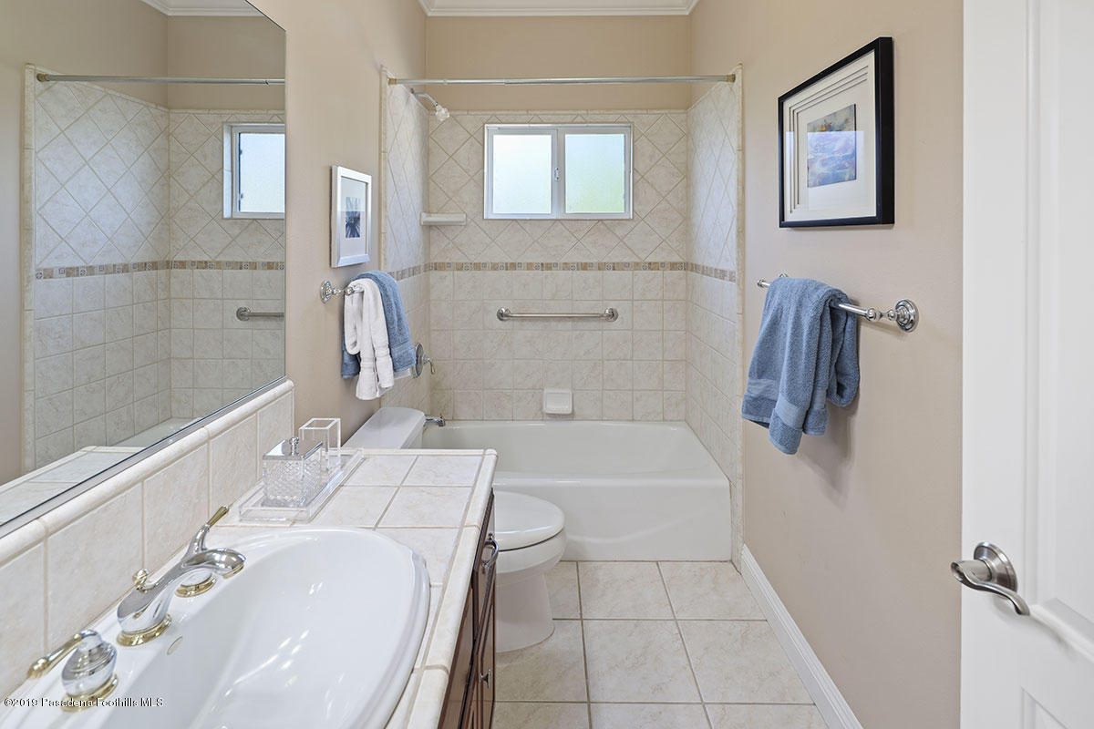 7215 Summitrose Street Tujunga, CA 91042 - Photo 33 of 47 a bathroom with a sink a bathtub and a shower