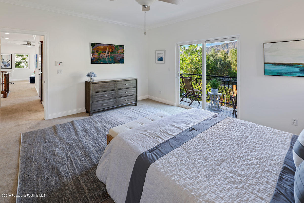 7215 Summitrose Street Tujunga, CA 91042 - Photo 34 of 47 a bedroom with a bed a dresser and a large window