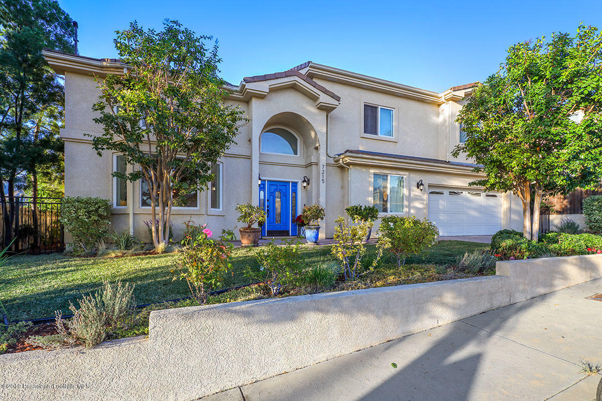 7215 Summitrose Street Tujunga, CA 91042 - Photo 4 of 47 a front view of a house with a yard