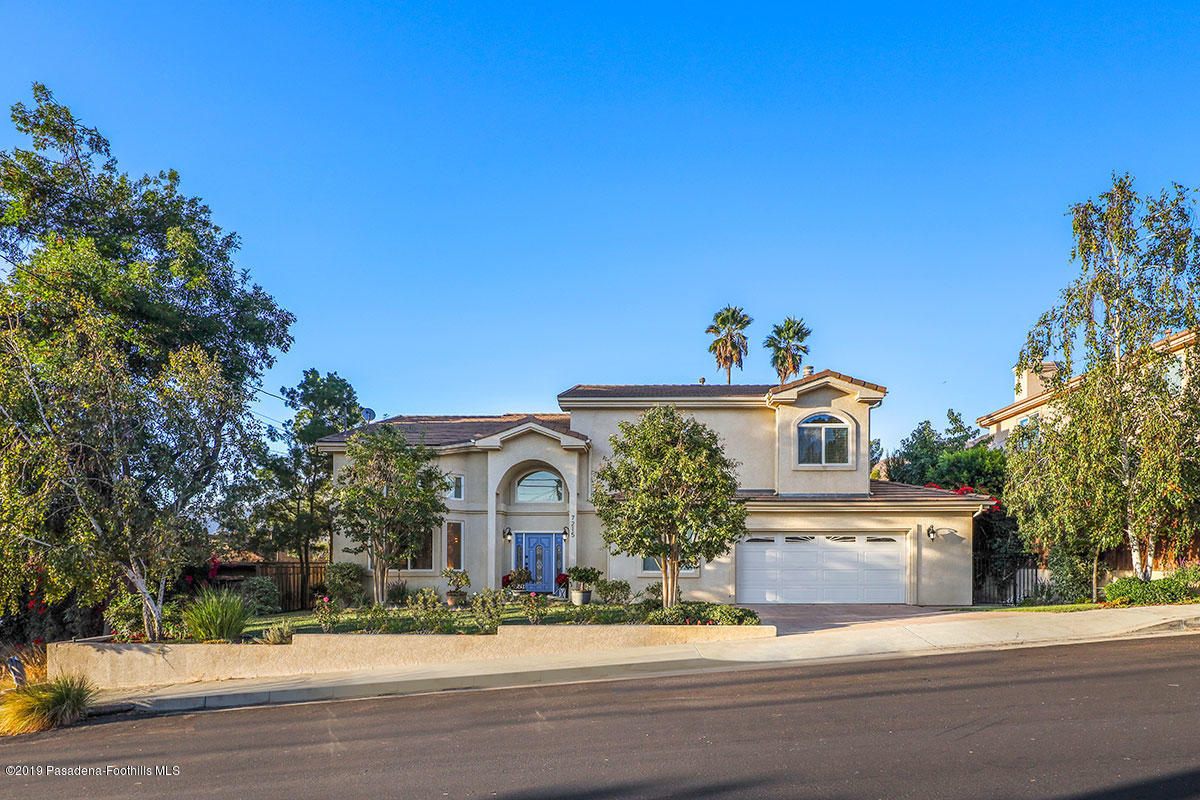 7215 Summitrose Street Tujunga, CA 91042 - Photo 5 of 47 a front view of a house with a yard