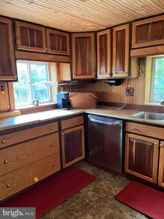a kitchen with stainless steel appliances granite countertop a sink dishwasher stove and cabinets