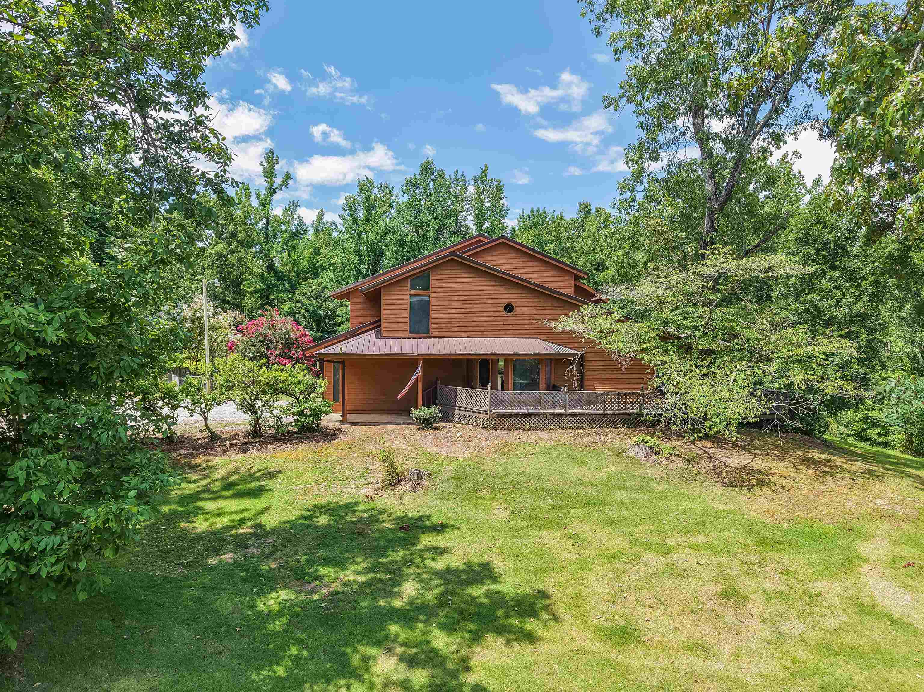 2380 Dunaway Road Selmer, TN 38375 - Photo 1 of 39 Brick-clad residence featuring a covered front porch and an expansive wood deck
