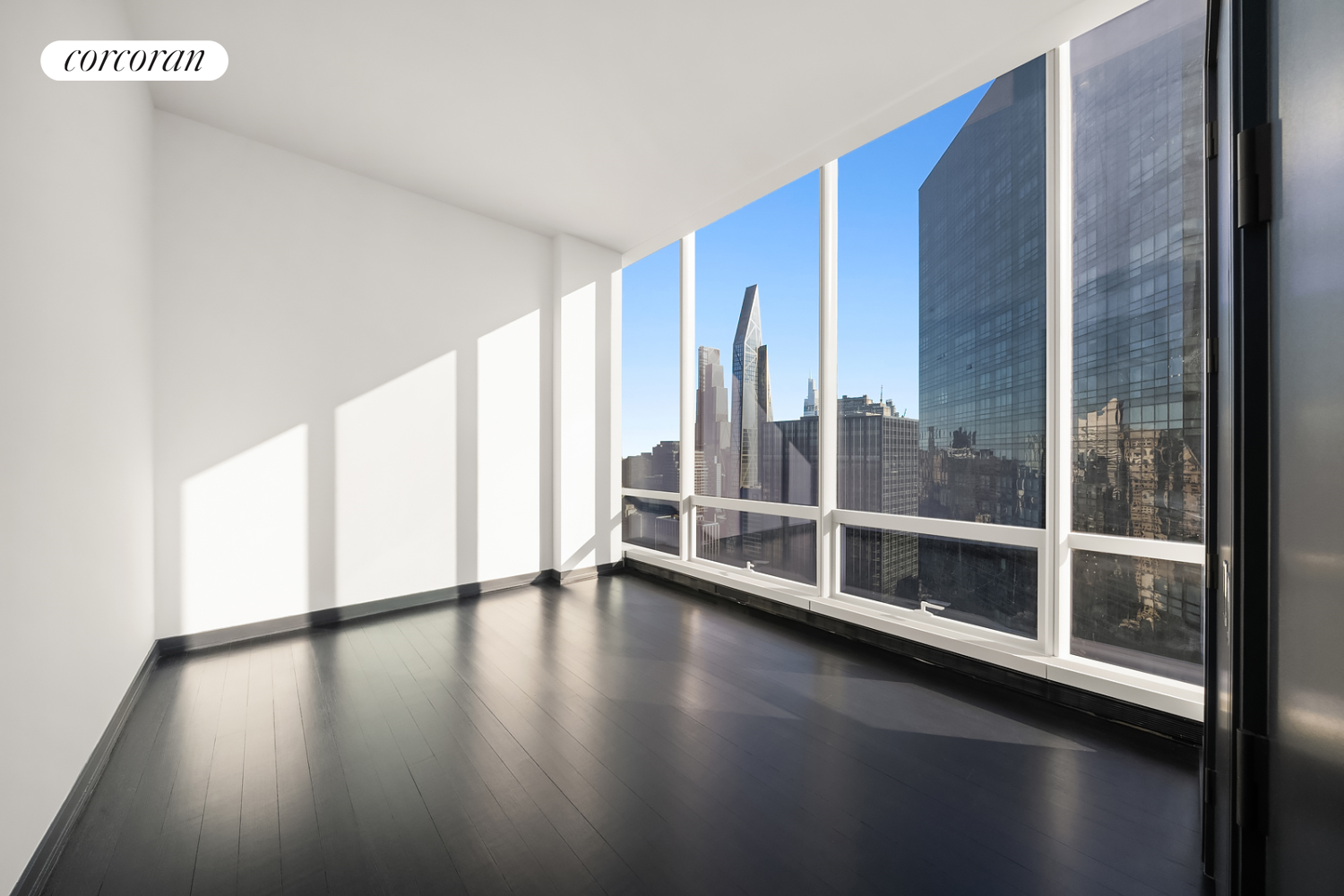 157 West 57th Street, Unit 56C Manhattan, NY 10019 - Photo 13 of 29 a view of an empty room with glass door