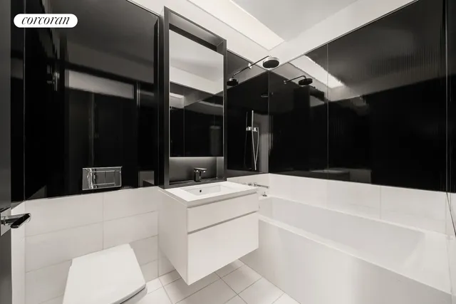 a bathroom with a sink a toilet and mirror