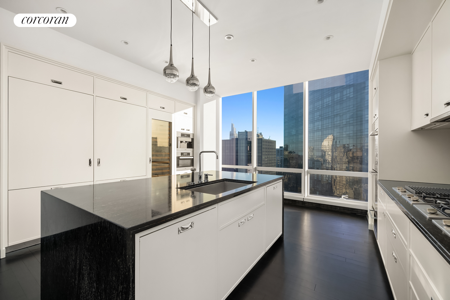 157 West 57th Street, Unit 56C Manhattan, NY 10019 - Photo 9 of 29 a kitchen with stainless steel appliances a sink a stove a refrigerator and wooden cabinets