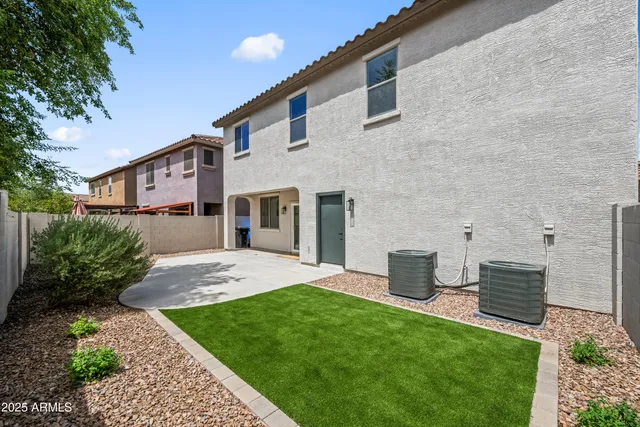 a front view of a house with a yard and a garage