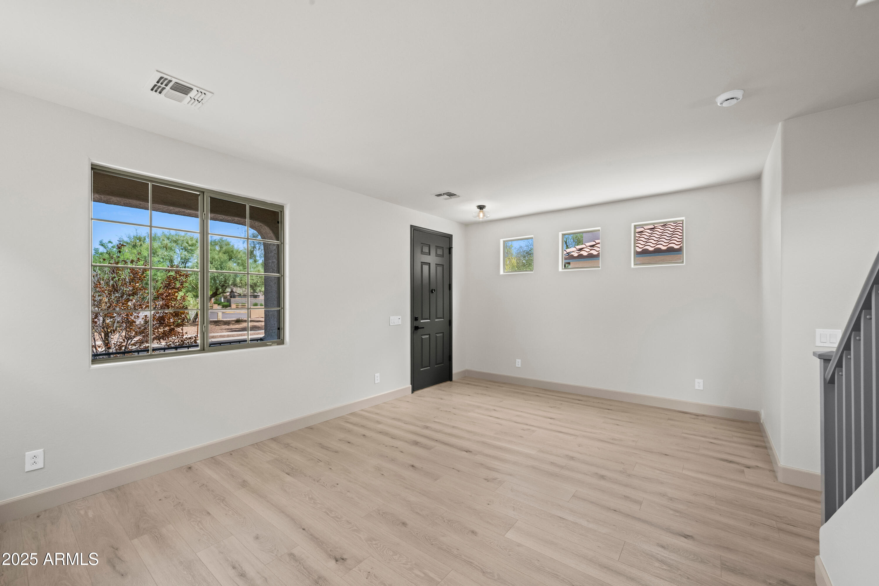 3745 East Flamingo Way Gilbert, AZ 85297 - Photo 16 of 25 a view of an empty room with wooden floor and a window
