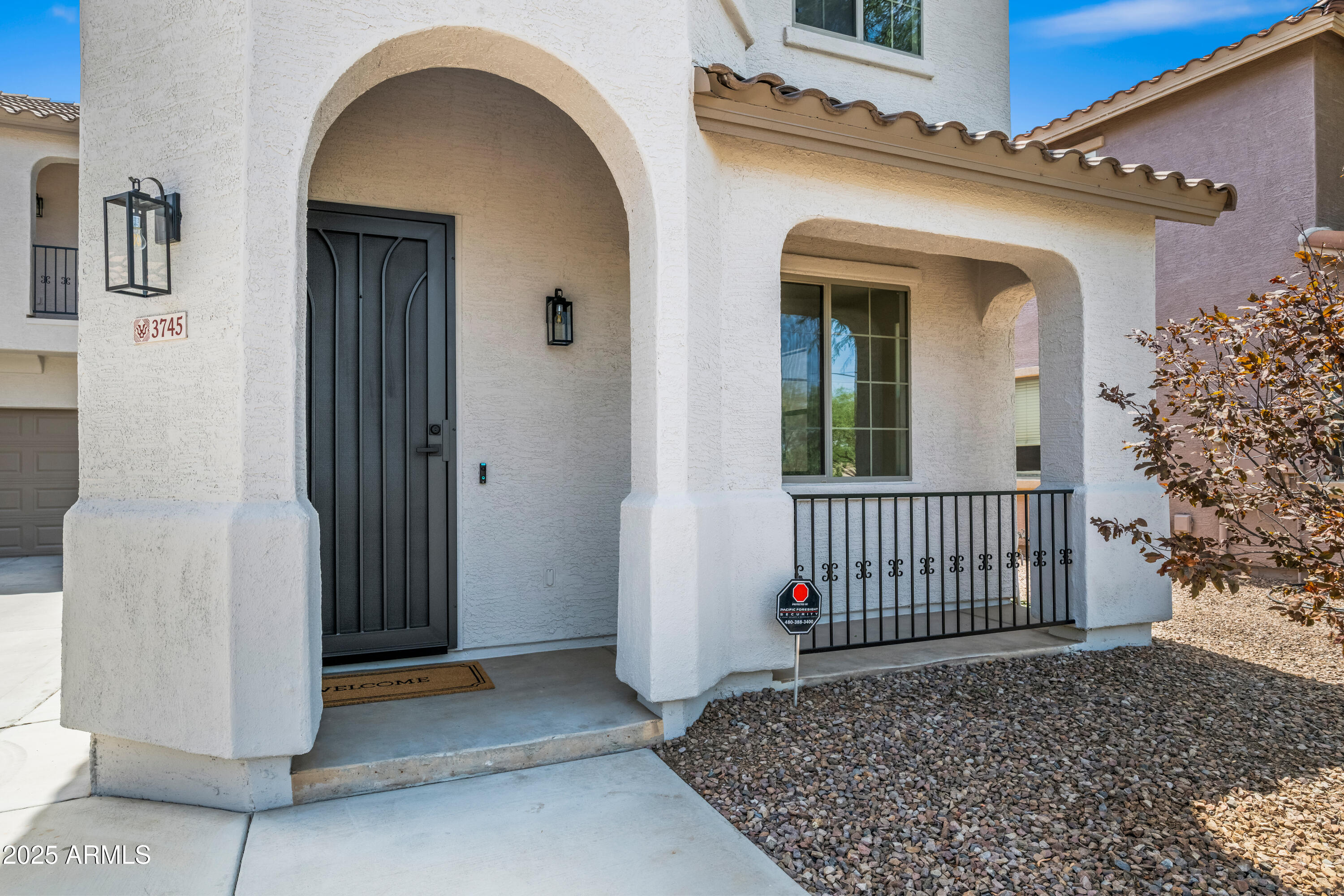 3745 East Flamingo Way Gilbert, AZ 85297 - Photo 2 of 25 a view of a house with a door and wooden fence