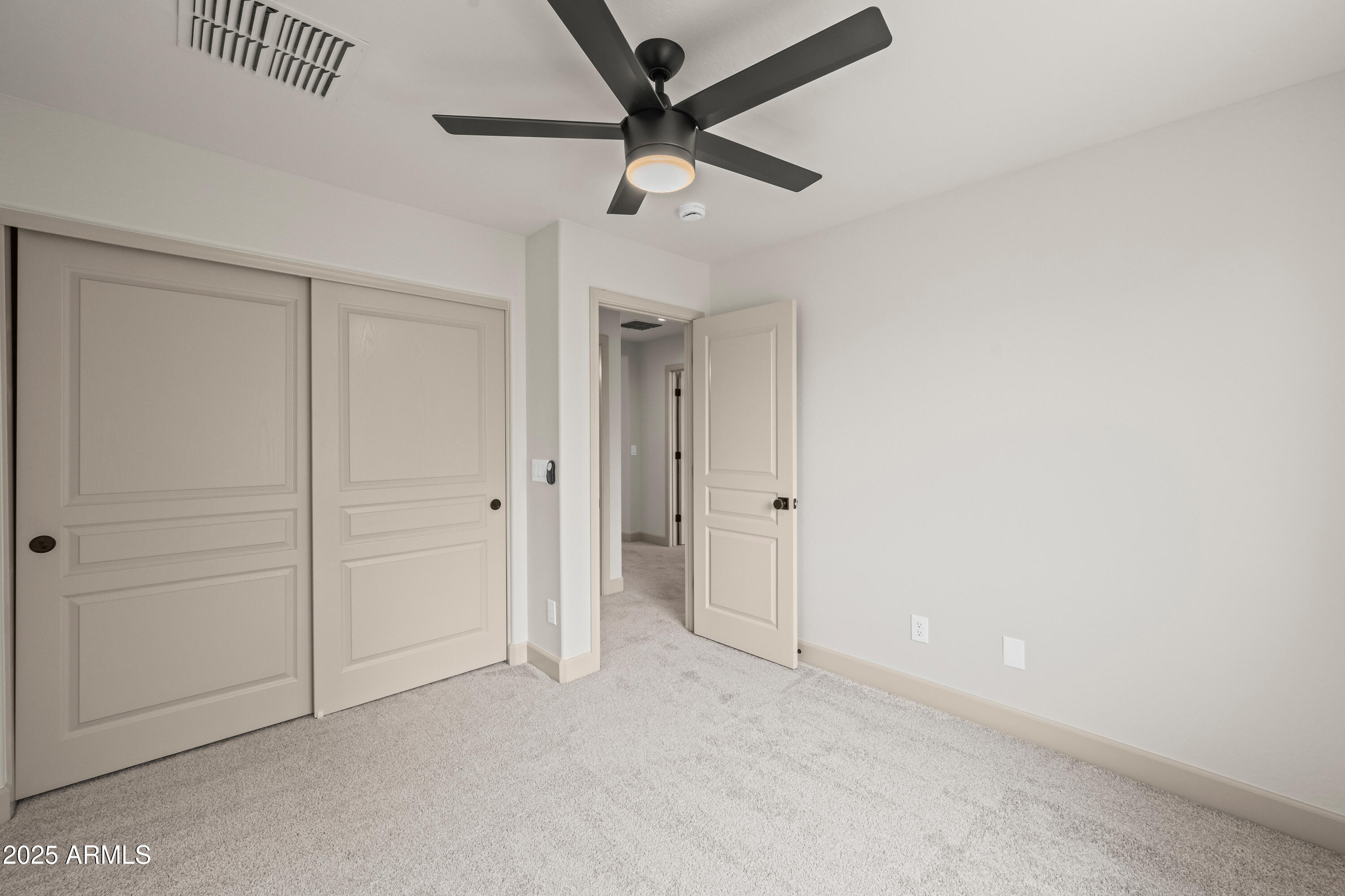 3745 East Flamingo Way Gilbert, AZ 85297 - Photo 23 of 25 an empty room with a ceiling fan and a window