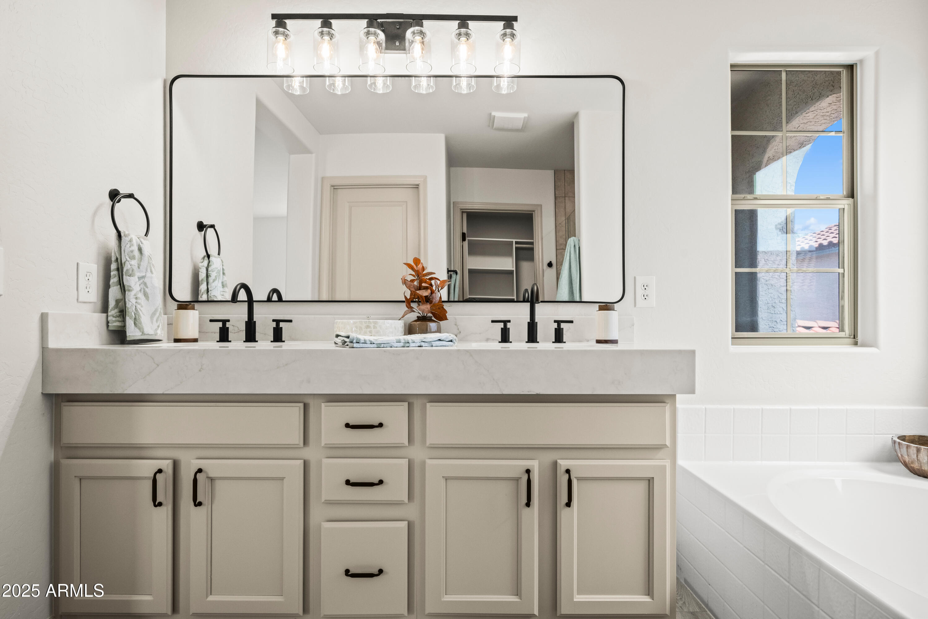 3745 East Flamingo Way Gilbert, AZ 85297 - Photo 3 of 25 a bathroom with double vanity sink a mirror and a