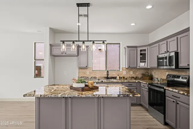 a kitchen with stainless steel appliances a sink stove and refrigerator