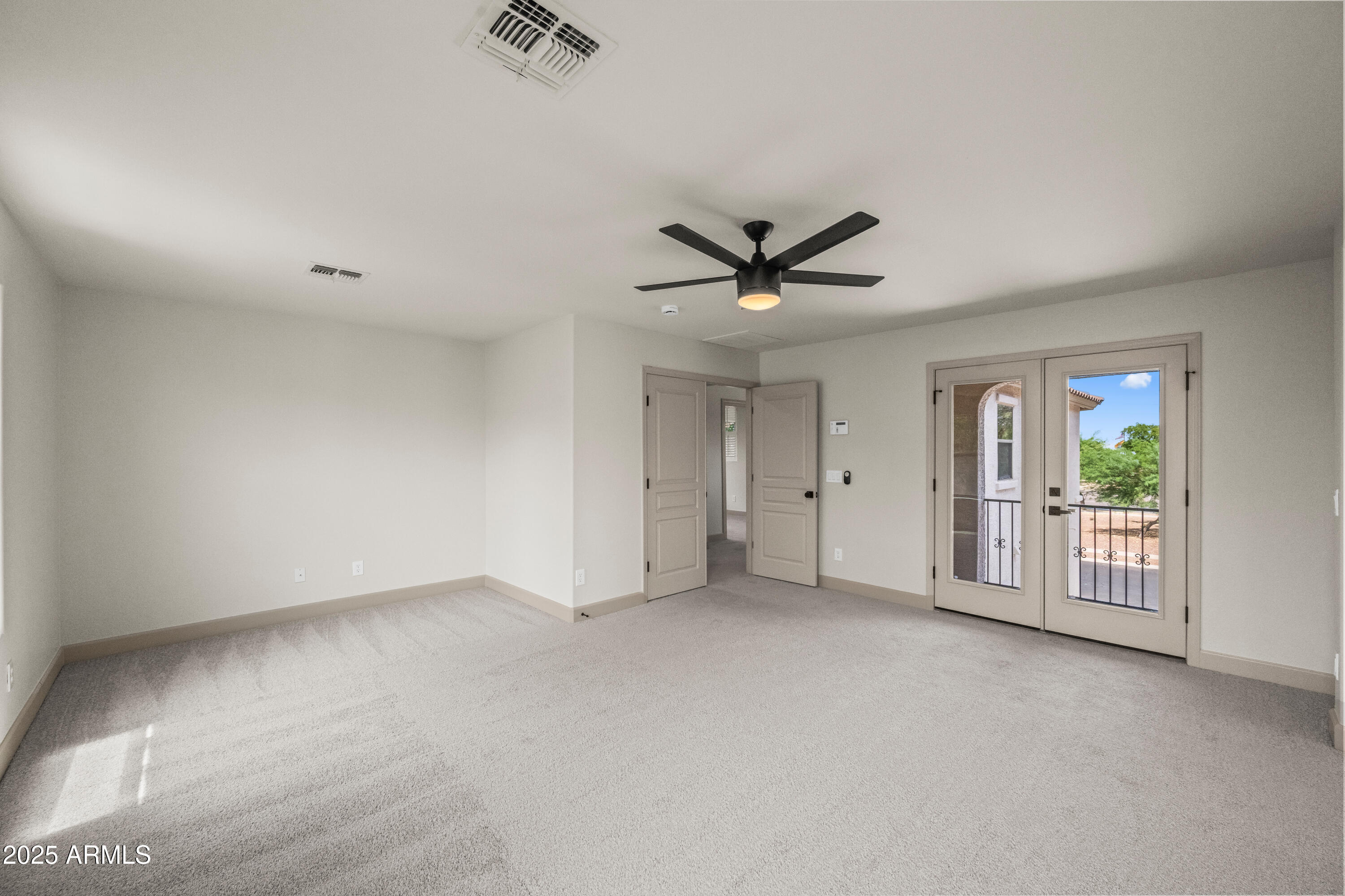 3745 East Flamingo Way Gilbert, AZ 85297 - Photo 8 of 25 an empty room with ceiling fan and windows