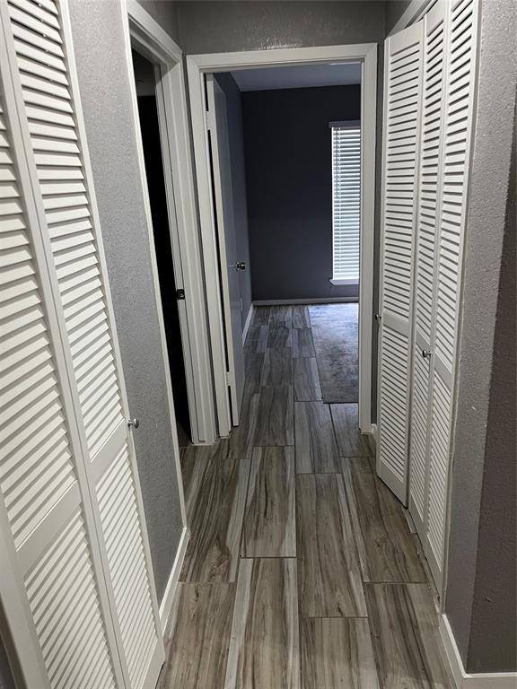 4845 Cedar Springs Road, Unit 170 Dallas, TX 75219 - Photo 13 of 26 a view of a hallway with wooden floor