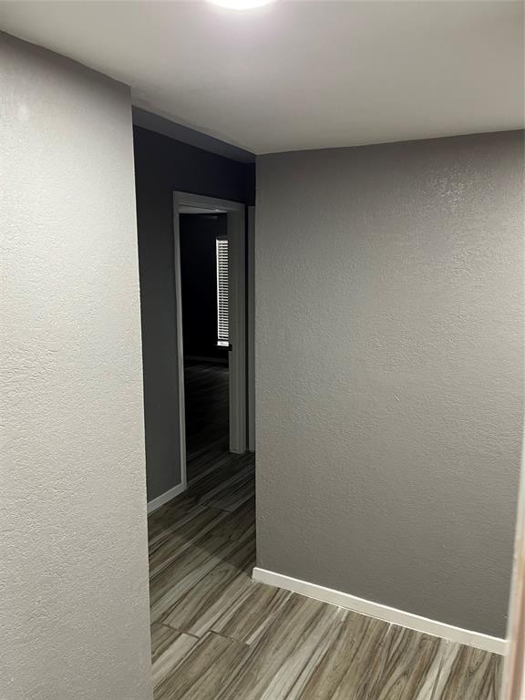 4845 Cedar Springs Road, Unit 170 Dallas, TX 75219 - Photo 14 of 26 a view of a hallway with wooden floor
