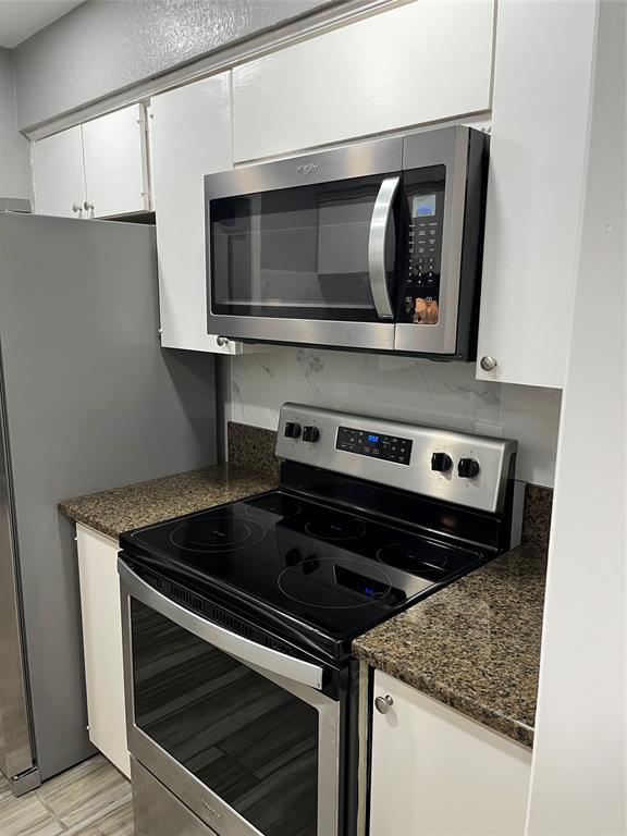 4845 Cedar Springs Road, Unit 170 Dallas, TX 75219 - Photo 16 of 26 a stove top oven sitting inside of a kitchen