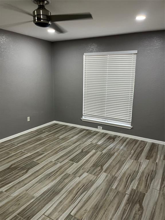 4845 Cedar Springs Road, Unit 170 Dallas, TX 75219 - Photo 23 of 26 an empty room with wooden floor and windows