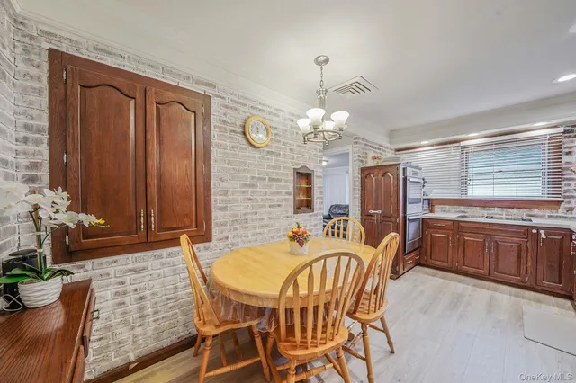 a dining room with furniture a chandelier and window