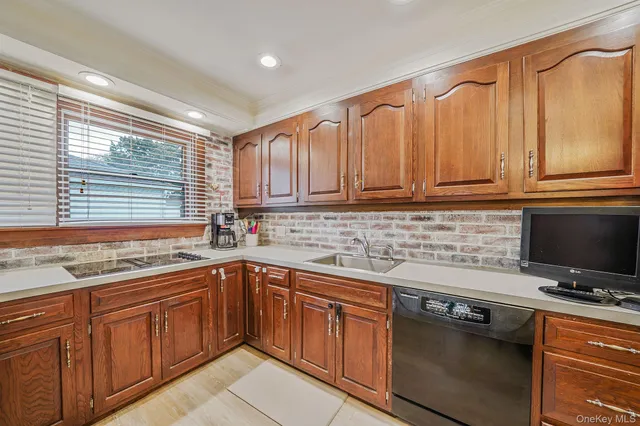 a kitchen with stainless steel appliances granite countertop a sink a stove and cabinets