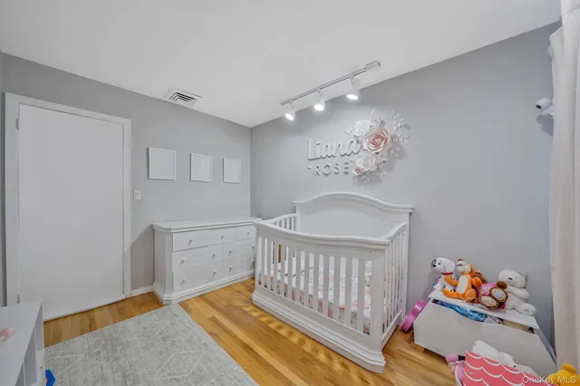 a bedroom with furniture and a baby crib