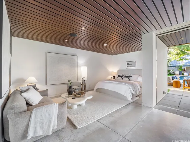 a large bedroom with a bed and a large window