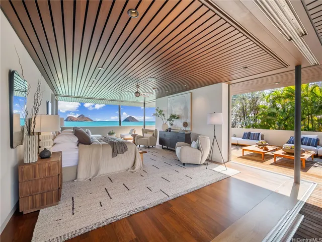 a living room with patio furniture and a garden