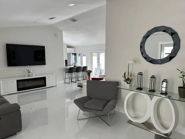 a living room with furniture a fireplace and a flat screen tv