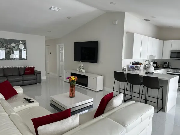 a living room with furniture and a flat screen tv