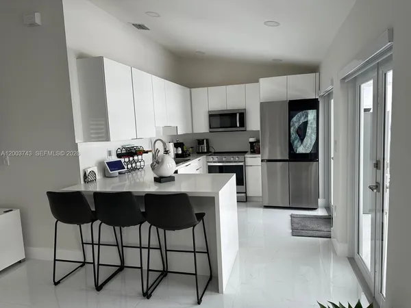 a kitchen with a sink cabinets and stainless steel appliances