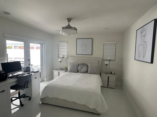 a bedroom with a bed gym equipment and a window