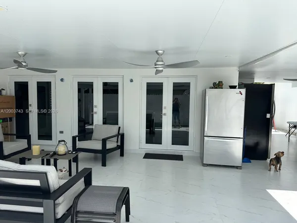 a view of a livingroom with furniture and a kitchen