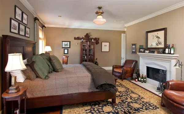 a bedroom with a bed a couch and dresser