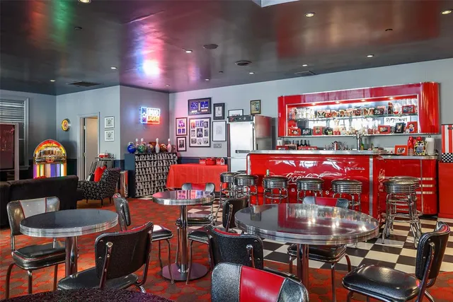 a room with lots of furniture and air hockey table