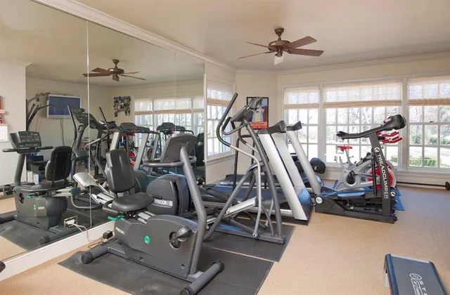 a room with pool table and windows