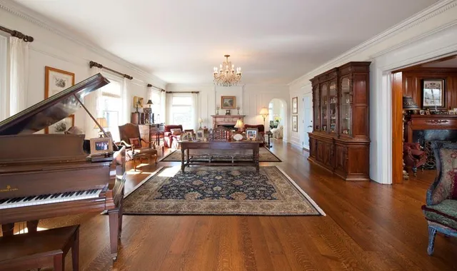 a living room with furniture and a book shelf
