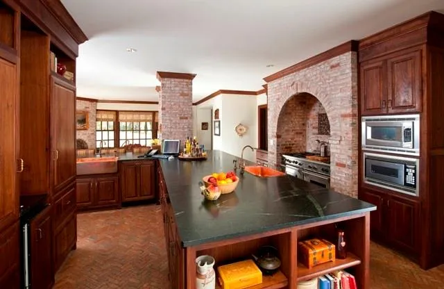 a kitchen view of living room stove and fireplace