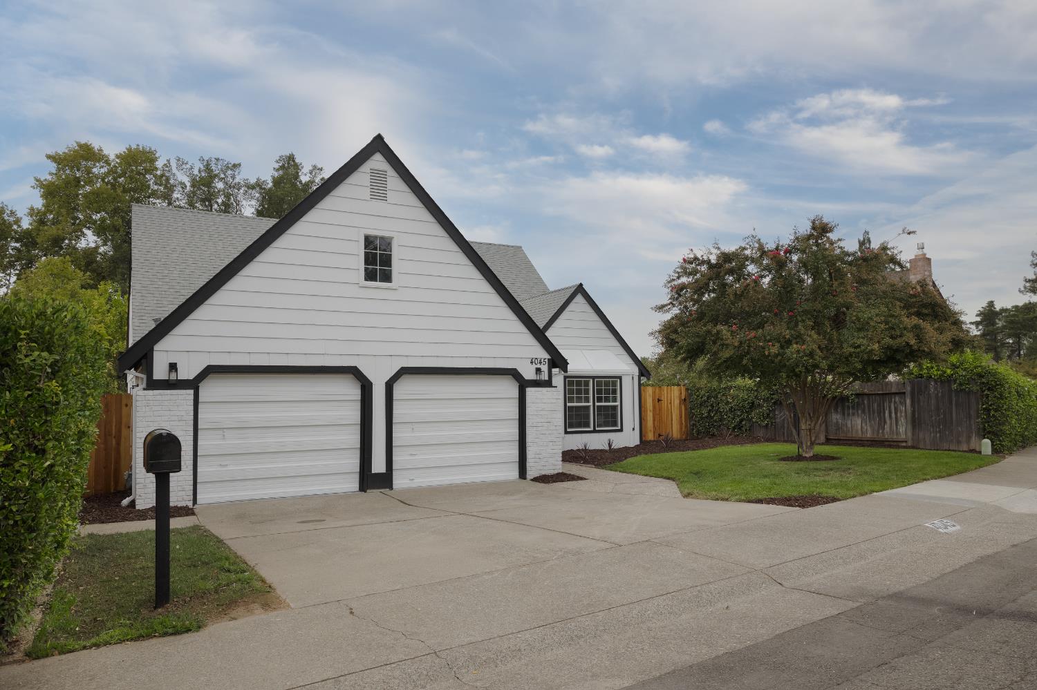 a view of a house with a yard and garage
